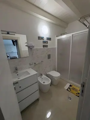 a bathroom with a toilet and a sink and a shower at Arena Dorada apartaments Margarita in Balestrate