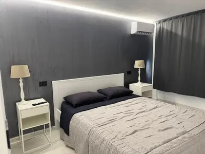 a bedroom with a large bed with two night stands at Suit home Archimede in Palermo
