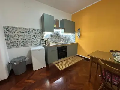 a kitchen with green and yellow walls and a table at My Space in Palermo
