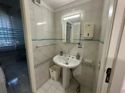 a white bathroom with a sink and a shower at My Space in Palermo