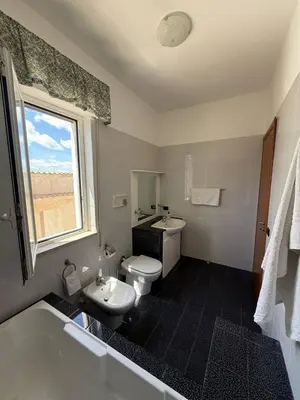 a bathroom with a toilet and a sink and a tub at 