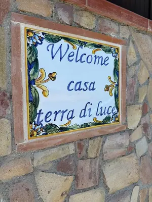 a welcome sign on a brick wall at 
