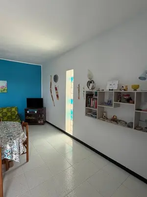 a room with a white wall and a table and a couch at 