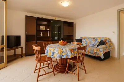 a living room with a table and a couch at Stella Del Mare in Castellammare del Golfo
