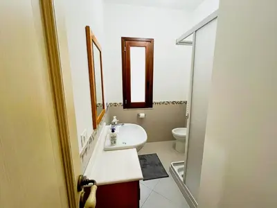 a bathroom with a white sink and a toilet at Casa Vacanza Acquanuova in Calatafimi