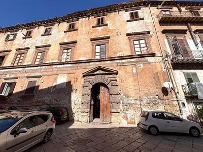 two cars parked in front of an old building at Ciak a Ballarò in Palermo