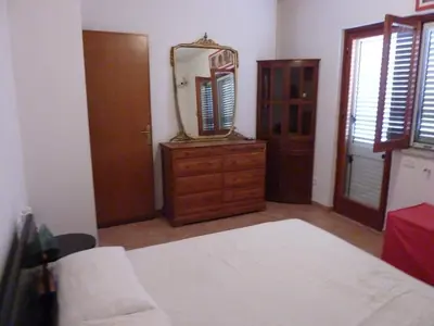 a bedroom with a bed and a mirror on a dresser at Terrazza 3F Mondello in Palermo