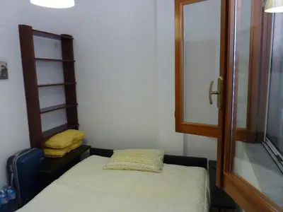 a small room with a bed and a mirror at Terrazza 3F Mondello in Palermo