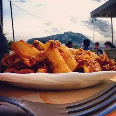a plate of food with french fries on a table at Terrazza 3F Mondello in Palermo