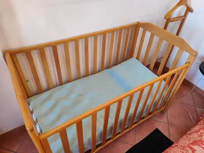 a wooden crib with a blue mattress in a room at Terrazza 3F Mondello in Palermo