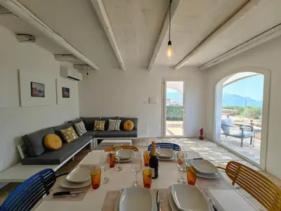 a living room with a table and a couch at Villa Teleffio in Castellammare del Golfo