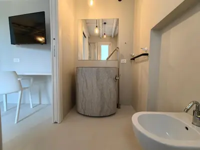 a bathroom with a shower and a sink and a tub at Villa Teleffio in Castellammare del Golfo