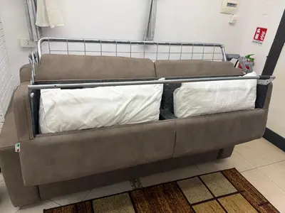 a couch with two pillows on it in a room at La Casa di Tiche in Palermo