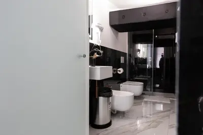 a bathroom with two sinks and two toilets at Palermo Luxury Rooms White in Palermo