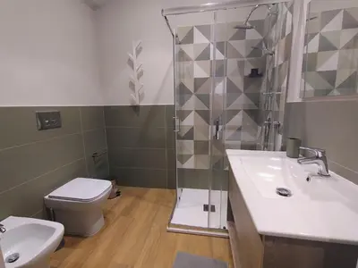 a bathroom with a shower and a toilet and a sink at Le Stanze del Massimo in Palermo