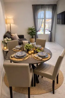 a dining room with a table and chairs and a kitchen at Mondello Sunshine Apartment in Mondello