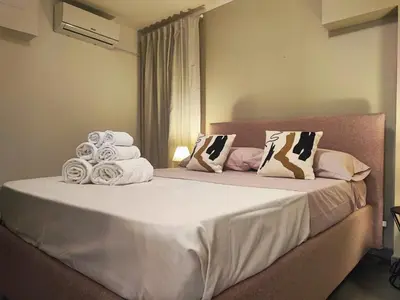 a bedroom with a bed with towels on it at Il rifugio del Capo in Palermo