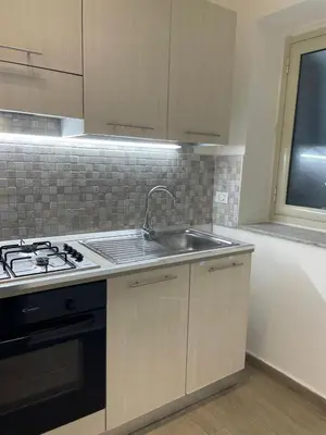 a kitchen with a sink and a stove at Dimora Normanna in Palermo