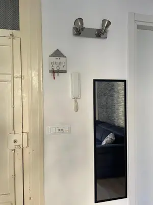 a mirror hanging on a wall next to a door at Dimora Normanna in Palermo