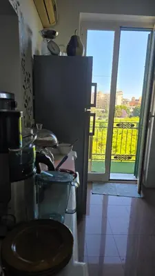 a kitchen with a counter with a window with a view at Cottage I Sollazzi in Palermo