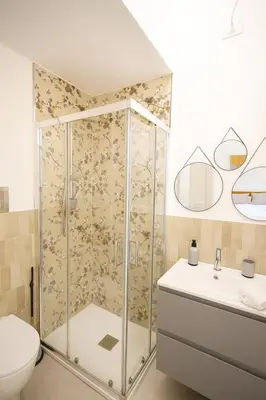 a bathroom with a shower with a toilet and a sink at Borgo di Mare in Palermo