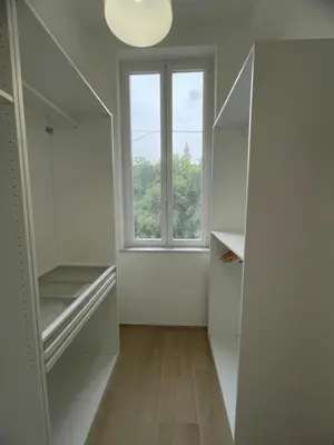 an empty room with a window and a mirror at Iazzu Apartament in Palermo