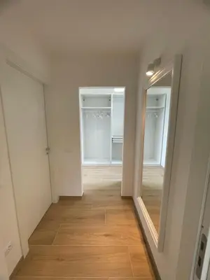 an empty room with a hallway with two mirrors at Iazzu Apartament in Palermo