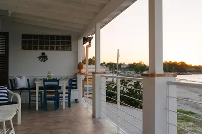 a patio with a table and chairs on a balcony at Le Terrazze sul mare Joelle -The uniqueness of the Terrace overlooking the sea in Carini