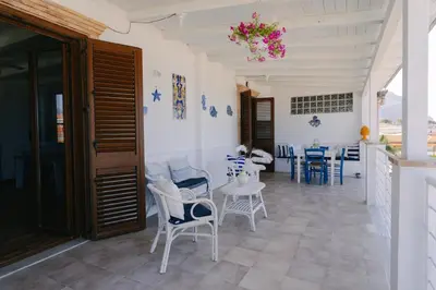 a bed in a bedroom with a painting on the wall at Le Terrazze sul mare Joelle -The uniqueness of the Terrace overlooking the sea in Carini