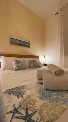a hotel room with two beds with star cushions at Ombelico di VenereVilla in Mandra Capreria