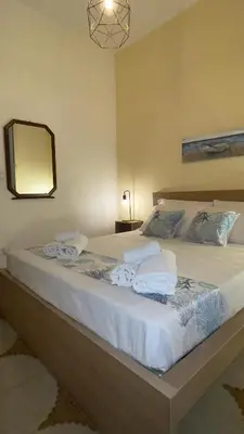 a bedroom with a large bed with towels on it at Ombelico di VenereVilla in Mandra Capreria