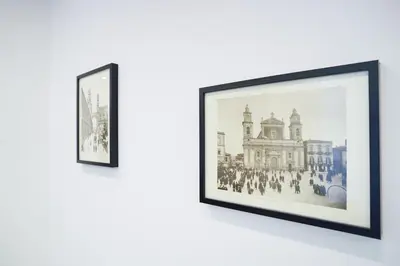 two framed photographs of a building on a wall at Mama suites Politeama in Palermo