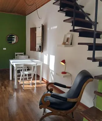 a living room with a table and a chair at Ballaria Pop Art in Palermo