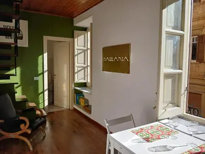 a room with a white table and a green wall at Ballaria Pop Art in Palermo