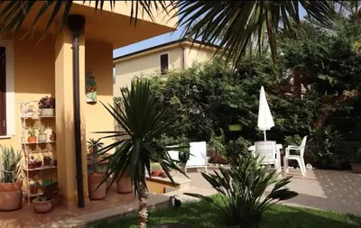 a patio with a table and chairs and plants at Homedaf in Carini