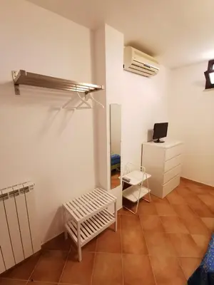 a white room with a bench and a desk at Homedaf in Carini