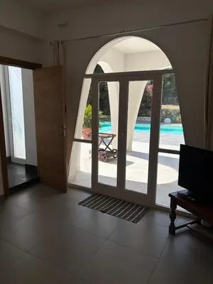 an open door to a patio with a view of a pool at Villa Grasta, Nuova Esclusiva con Piscina in Capaci