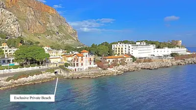 a group of buildings next to a body of water at Mondello D'Amare in Palermo