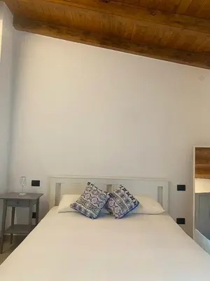 a bedroom with a bed with two pillows on it at Ma Home in Cinisi