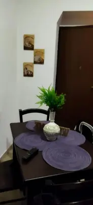 a table with purple plates and a plant on it at A 2 passi dal Politeama in Palermo