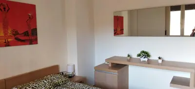 a bedroom with a mirror on the wall and a bed at A 2 passi dal Politeama in Palermo
