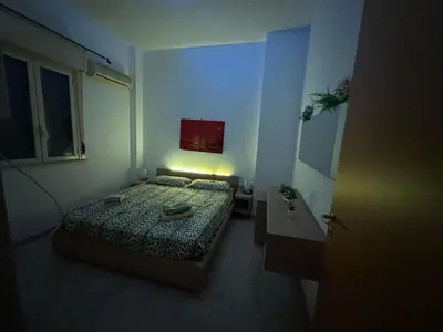 a small bedroom with a bed and a window at A 2 passi dal Politeama in Palermo