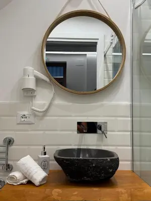 a bathroom with a black sink and a mirror at VUCCIRIA' S ROOM centro storico in Palermo