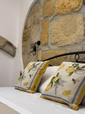 a bedroom with a bed with two pillows at VUCCIRIA' S ROOM centro storico in Palermo