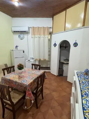 a kitchen and dining room with a table and chairs at Casa la Fenice in Palermo