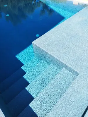 a pool of water with a reflection in the water at La Marina Pool Villa in Trappeto