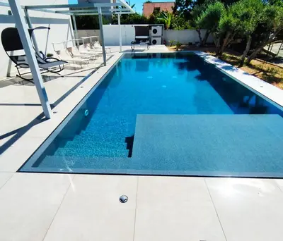 a swimming pool with blue water in a house at La Marina Pool Villa in Trappeto