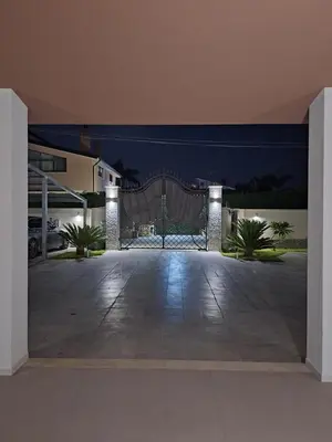 an open gate to a driveway at night at La Marina Pool Villa in Trappeto