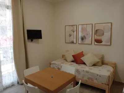 a bedroom with a bed and a table and a window at Butterfly Apartments in Palermo