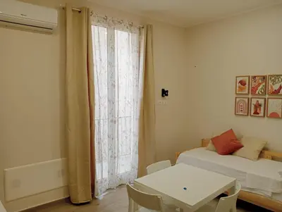a kitchen with a table and chairs in a room at Butterfly Apartments in Palermo